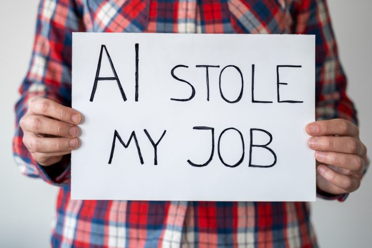 Anonymous person holding sign with inscription "AI stole my job"