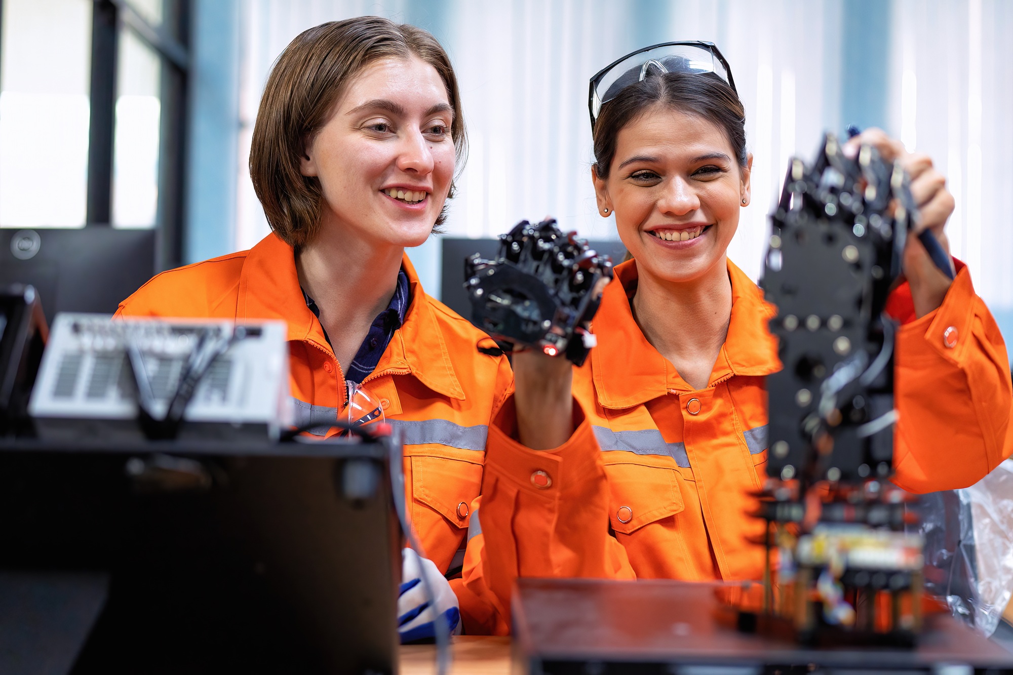 Girl engineer in robot industry fabrication research room simulate testing robot arm on operation